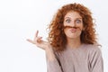 Close-up portrait playful, funny gorgeous redhead curly woman making goofy face, making moustache from hair strand and