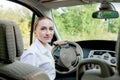 Close up portrait of pleasant looking female with glad positive expression, being satisfied with unforgettable journey by car,