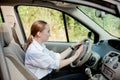 Close up portrait of pleasant looking female with glad positive expression, being satisfied with unforgettable journey by car,