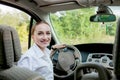 Close up portrait of pleasant looking female with glad positive expression, being satisfied with unforgettable journey by car,