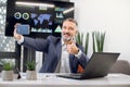 Close up portrait of pleasant mature bearded businessman with gray hair, making selfie photo and showing thumb up, while Royalty Free Stock Photo