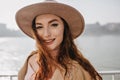 Close-up portrait of pleased ginger girl with white skin. Outdoor shot of cheerful caucasian lady with long hairstyle