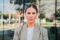 Close up portrait of powerful business woman looking serious at camera standing at workplace. Elegant office secretary