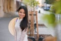 Close up portrait of pretty asian girl dressed in Ao Dai dress with vietnamese conical hat against arches background. Royalty Free Stock Photo