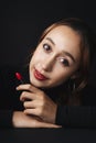 Close up portrait of pretty beautiful young woman wearing black sweater isolate over dark background. Beauty in the dark. Woman