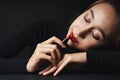 Close up portrait of pretty beautiful young woman wearing black sweater isolate over dark background. Beauty in the dark. Woman