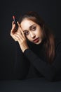 Close up portrait of pretty beautiful young woman wearing black sweater isolate over dark background. Beauty in the dark. Woman