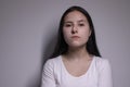 Portrait of pensive thoughtful girl, looking seriously brunette. on grey background with copy space. lifestyle concept Royalty Free Stock Photo