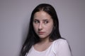 Portrait of pensive thoughtful girl, looking seriously brunette. on grey background with copy space. lifestyle concept Royalty Free Stock Photo