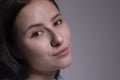 Portrait of pensive thoughtful girl, looking seriously brunette. on grey background with copy space. lifestyle concept Royalty Free Stock Photo