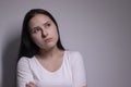 Portrait of pensive thoughtful girl, looking seriously brunette. on grey background with copy space. lifestyle concept Royalty Free Stock Photo