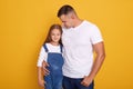 Close up portrait of pretty little girl andher dad, young father hugging her beautiful charming female kid, family looking at Royalty Free Stock Photo