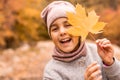 Close-up portrait of pretty little girl resting in autumnal park Royalty Free Stock Photo