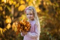 Close-up portrait of pretty little girl resting in autumnal park Royalty Free Stock Photo