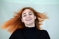 Close up portrait of pretty redhead girl with long wavy hair blowing on the wind Royalty Free Stock Photo