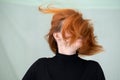 Close up portrait of pretty redhead girl with long wavy hair blowing on the wind Royalty Free Stock Photo