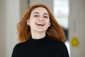 Close up portrait of pretty redhead girl with long wavy hair blowing on the wind Royalty Free Stock Photo