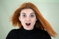 Close up portrait of pretty redhead girl with long wavy hair blowing on the wind Royalty Free Stock Photo