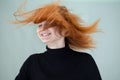 Close up portrait of pretty redhead girl with long wavy hair blowing on the wind Royalty Free Stock Photo