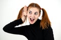 Close up portrait of pretty redhead teenage girl holding a hand to her ear listening to a secret Royalty Free Stock Photo