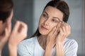 Closeup portrait gorgeous woman holding tweezers plucks eyebrows Royalty Free Stock Photo