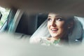 Close-up portrait of a pretty shy bride in a car window Royalty Free Stock Photo