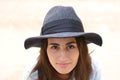 Close-up portrait of pretty smiling young woman with natural skin and gray hat looking at camera Royalty Free Stock Photo