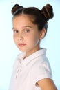 Close-up portrait of a pretty stylish brunette child girl looks seriously and attentively