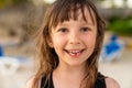 A close-up portrait of a pretty 6 year old girl with one missing tooth. Funny toothless smile Royalty Free Stock Photo