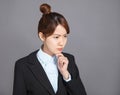 Close up portrait of pretty young business woman thinking Royalty Free Stock Photo