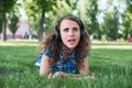Close up portrait of Pretty young girl listening music lying Royalty Free Stock Photo