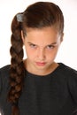 Close-up portrait of pretty young schoolgirl. She is serious and demanding