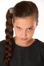 Close-up portrait of pretty young schoolgirl. She is serious and demanding