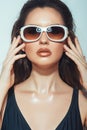 Close up portrait of pretty young woman with white glasses in luxury black bikini. Female fashion model posing with sunglasses. Royalty Free Stock Photo