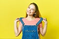 Close up portrait of a pretty young woman winking isolated yellow background Royalty Free Stock Photo