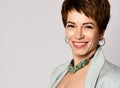 Close up portrait of a professional short hair business woman smiling on gray Royalty Free Stock Photo