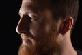 Close up of portrait of profile of a pensive man on black background Royalty Free Stock Photo