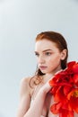 Close up portrait of a redheaded woman holding tulip flowers Royalty Free Stock Photo