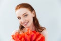 Close up portrait of a redheaded woman holding tulip flowers Royalty Free Stock Photo