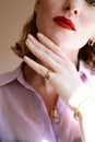 Close-up portrait of rich young woman smiling wearing expensive luxurious golden jewellery and luxury concept. Royalty Free Stock Photo