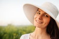 Close up portrait of a romantic attractive beautiful young woman with a hat and white shirt, smiling and looking at the camera on Royalty Free Stock Photo