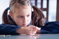 Close up portrait of sad and depressed business child girl counts coins. Concept of money, inflation and financial crisis