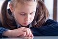 Close up portrait of sad and depressed business child girl counts coins. Concept of money, business, inflation and financial