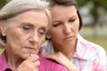 Close up portrait of sad senior woman with adult daughter Royalty Free Stock Photo