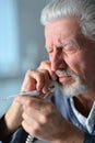 Portrait of sad sick senior man calling doctor Royalty Free Stock Photo