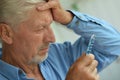 Portrait of sad sick senior man with pills Royalty Free Stock Photo