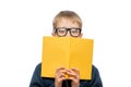 Close-up portrait of a schoolboy wearing glasses with a textbook