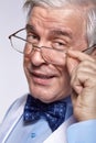 Close up portrait of senior businessman clerk with glasses looking ironically at the camera Royalty Free Stock Photo