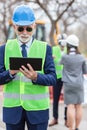 Close-up portrait of senior gray-haired businessman or engineer working on a tablet while visiting construction site Royalty Free Stock Photo