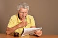 Close up portrait of senior man reading newspaper Royalty Free Stock Photo